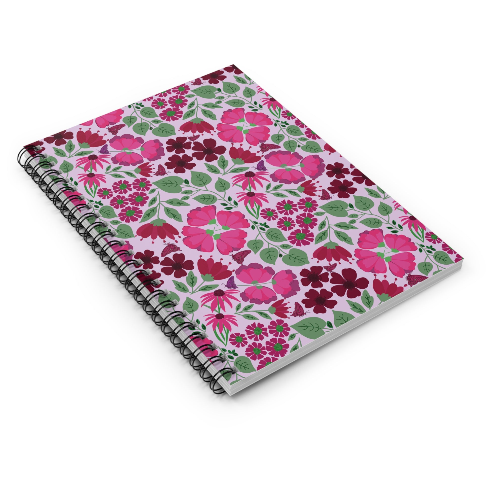 Floral Spiral Notebook with a pink background features vibrant floral patterns and a sleek black wire binding, embodying the joyful, uplifting designs of FireBrook Essentials. Perfect for creative note-taking and sketching.