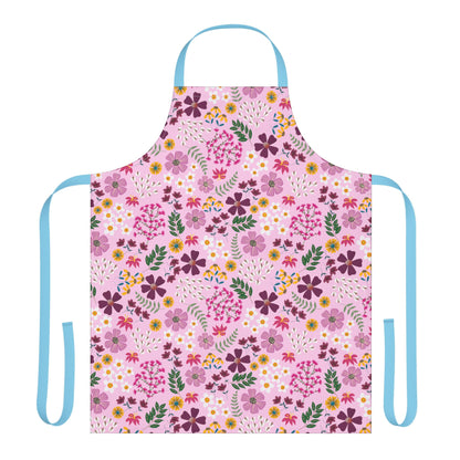 Floral Apron: A stylish, full-coverage kitchen apron featuring a vibrant floral pattern on a soft pink background, complemented by light blue ties, perfect for enhancing joyful cooking experiences.