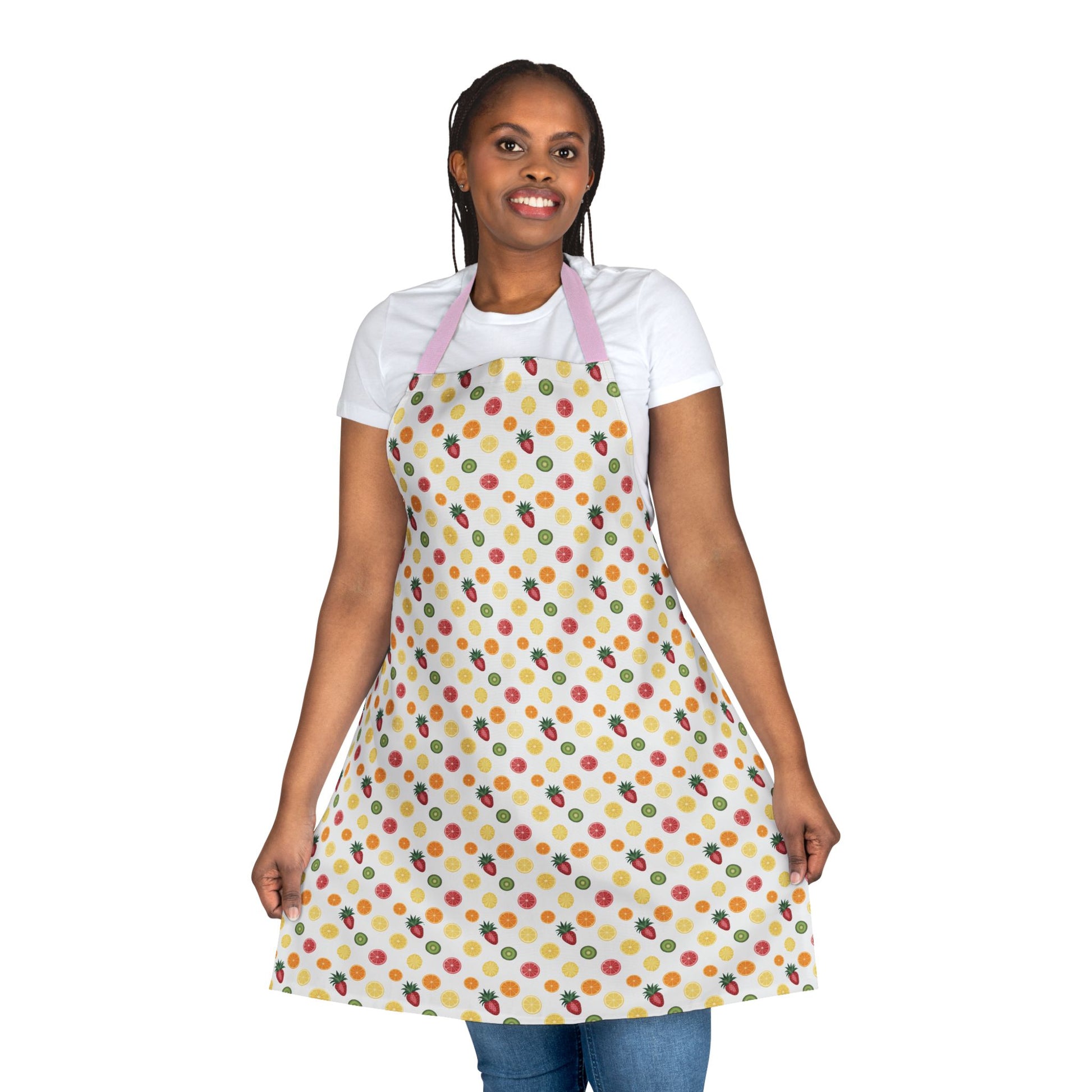 Woman smiling, wearing Apron, Fruit Slice Design, 5-Color Straps, adorned with vibrant fruit patterns, ideal for culinary enthusiasts, showcasing FireBrook Designs' blend of style and practicality.