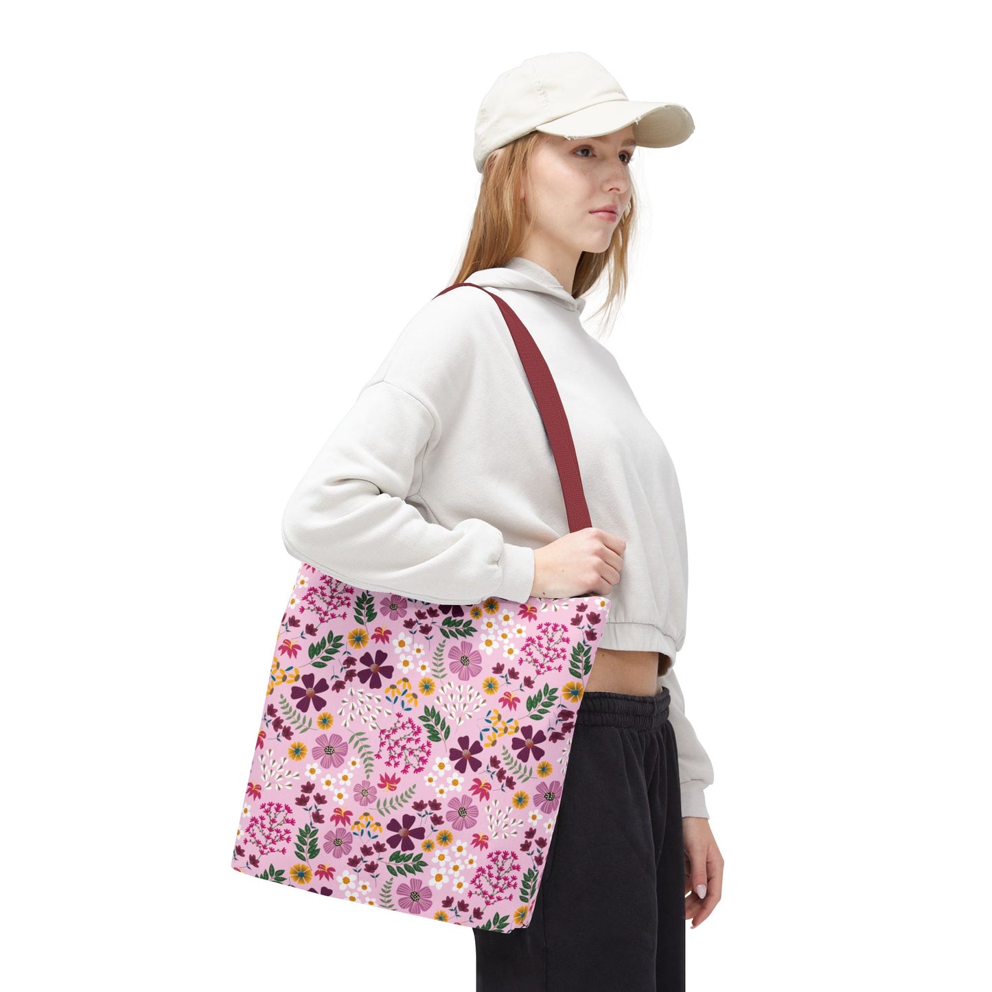 Model carrying a Floral Tote Bag with a pink floral pattern, showcasing its spacious design and durability, complemented by reinforced stitching and boxed corners, perfect for daily essentials.