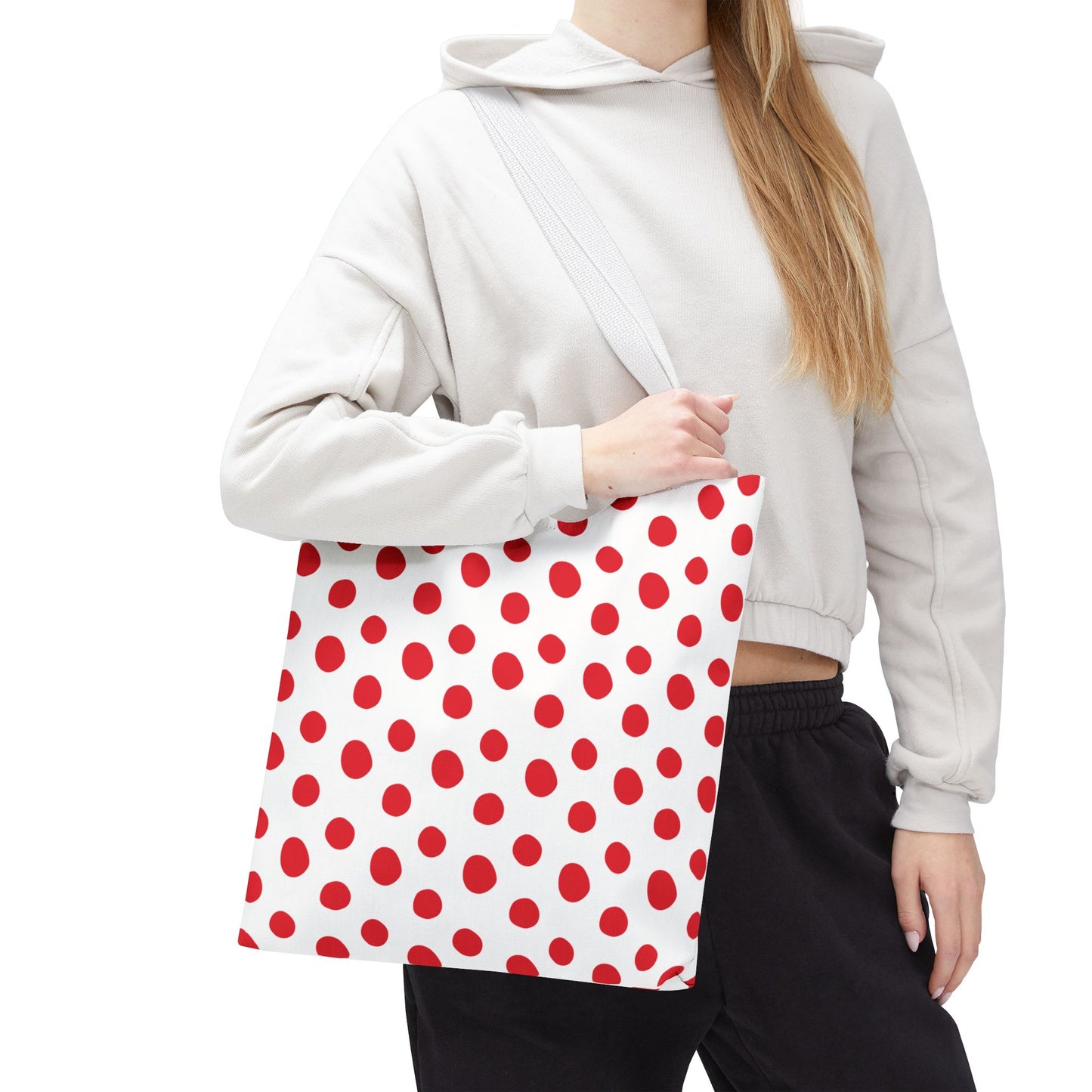 Red Polka Dots Tote Bag: A hand holds a stylish tote adorned with vibrant red polka dots, showcasing its playful design. Ideal for everyday use, this durable accessory adds a cheerful touch to any outing.