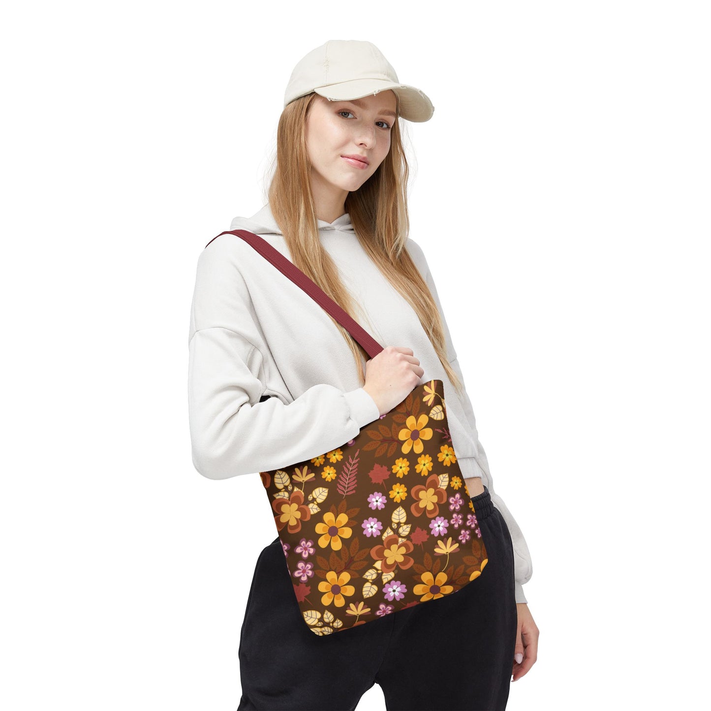 Young woman models the Floral Tote Bag, featuring a dark brown backdrop with vibrant autumnal flowers. Ideal for cheerful summer outings, it's durable and stylish, embodying FireBrook Essentials' commitment to joyful, uplifting designs.