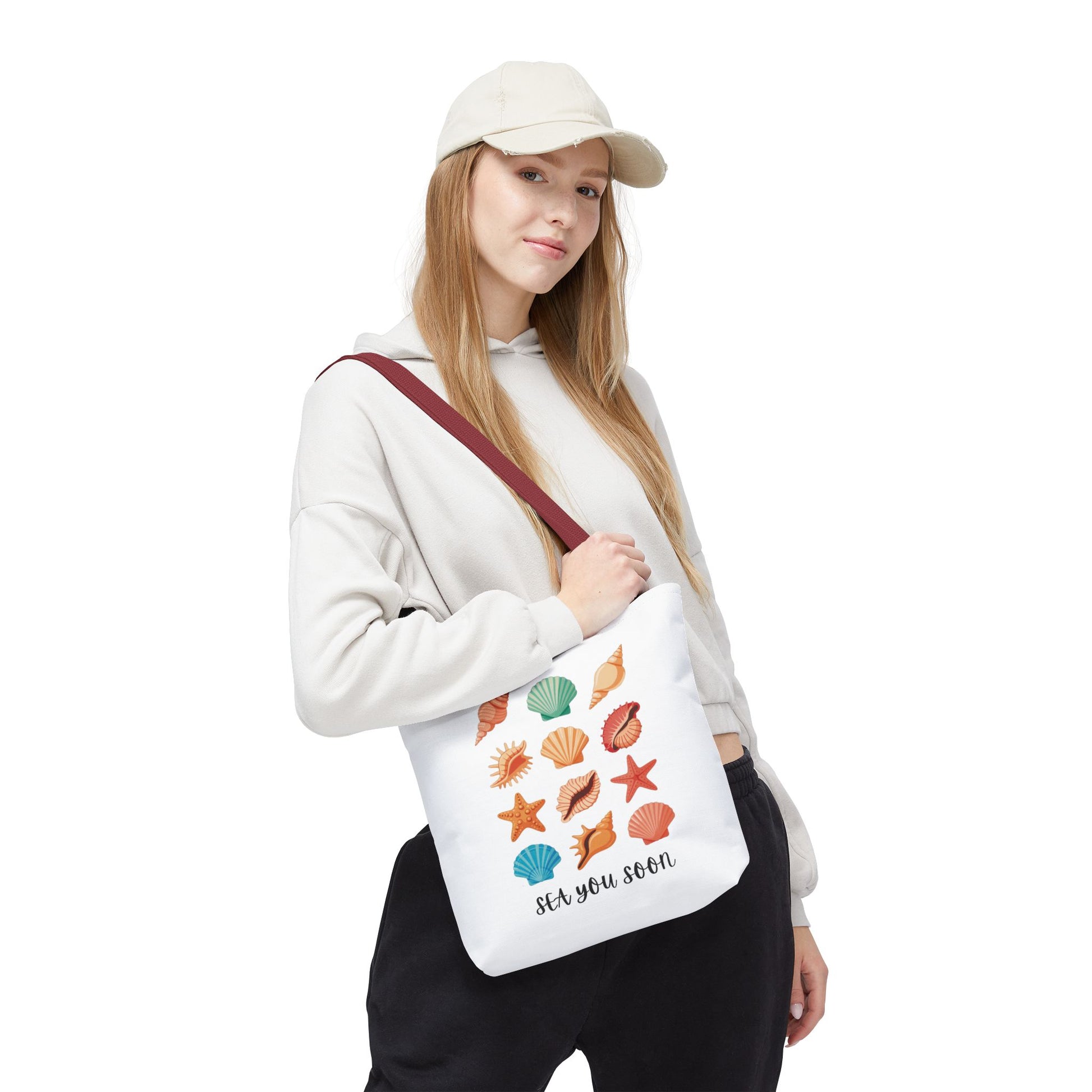 Sea You Soon Sea Shells Tote Bag with a summery beach design, featuring sea shells. Ideal for ocean lovers, it offers durability with reinforced handles and boxed corners for extra space.