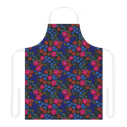 Apron Floral Design: A vibrant kitchen apron with a dense floral pattern in pink, red, blue, and mustard-yellow, featuring solid-white neck and waist ties, crafted for comfort and style.