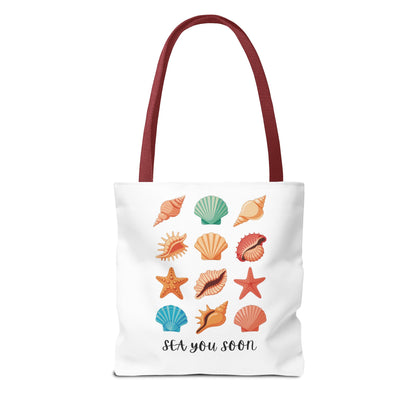 The Sea You Soon Sea Shells Tote Bag showcases a beachy design with seashells, perfect for coastal living. This durable, stylish bag from FireBrook Essentials is ideal for beach trips and casual outings.