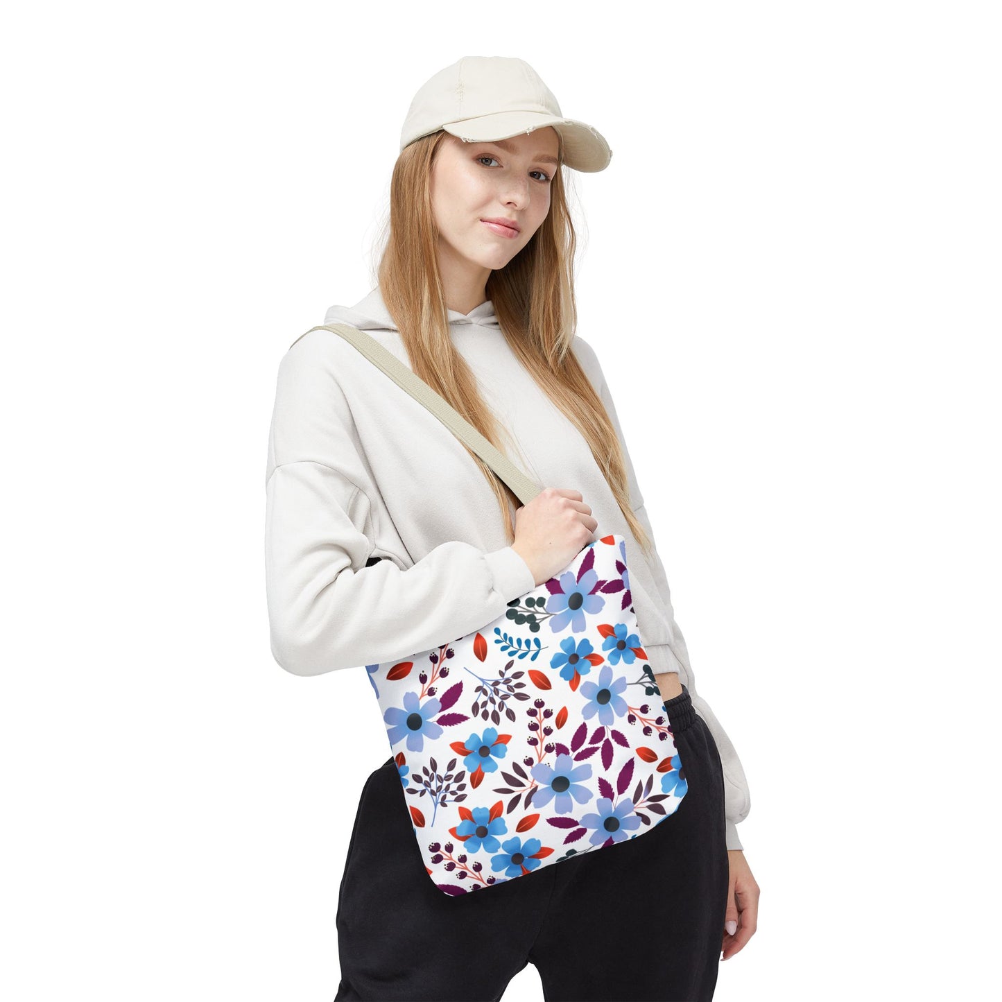 Young woman models the Floral Tote Bag with a vibrant blue, red, and purple floral pattern, ideal for summer outings, reflecting FireBrook Designs' joyful and stylish approach.