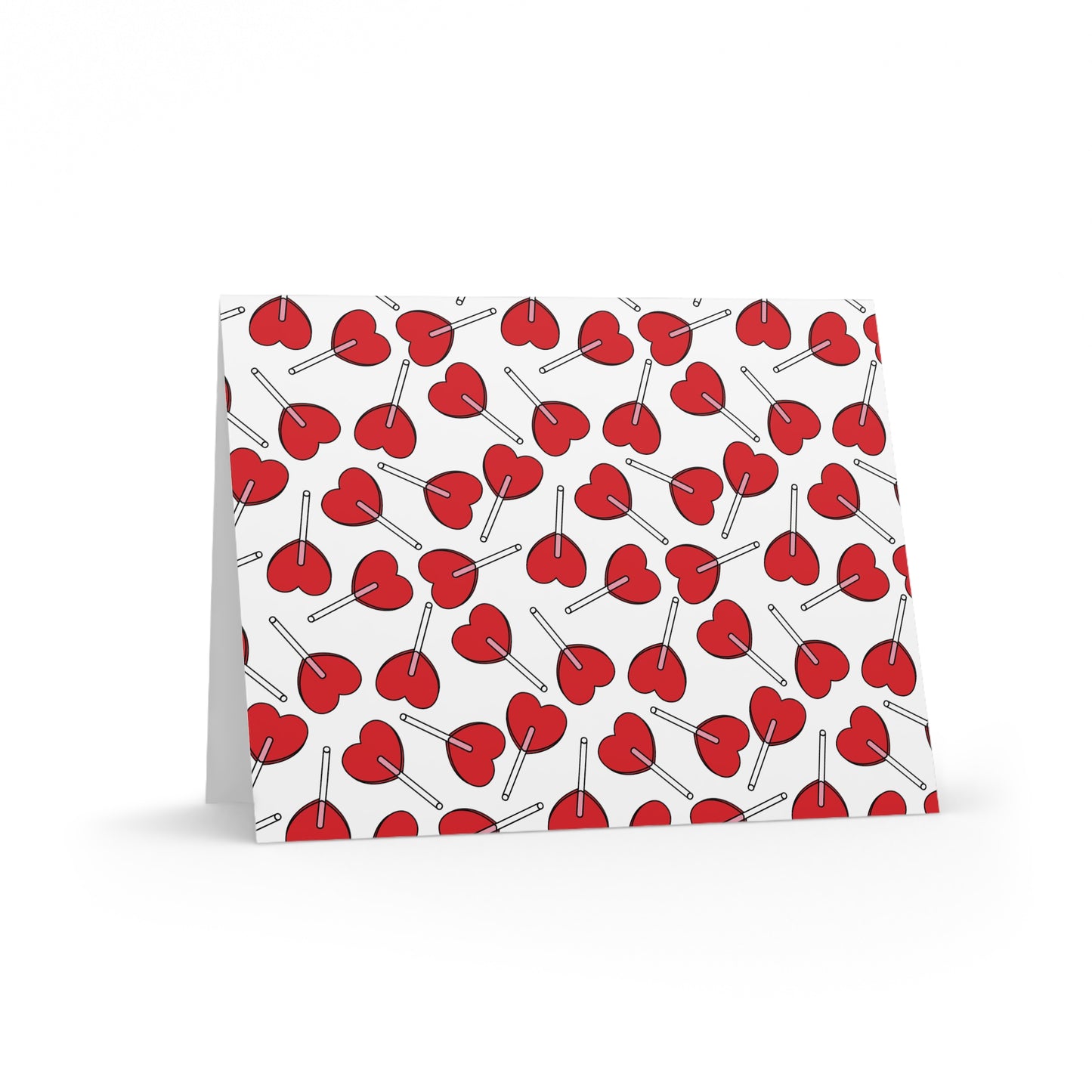 Love Greeting Cards — Pack of 8/16/24 features a folded card adorned with red, heart-shaped lollipops on a white background. Comes with a matching envelope, perfect for heartfelt messages.