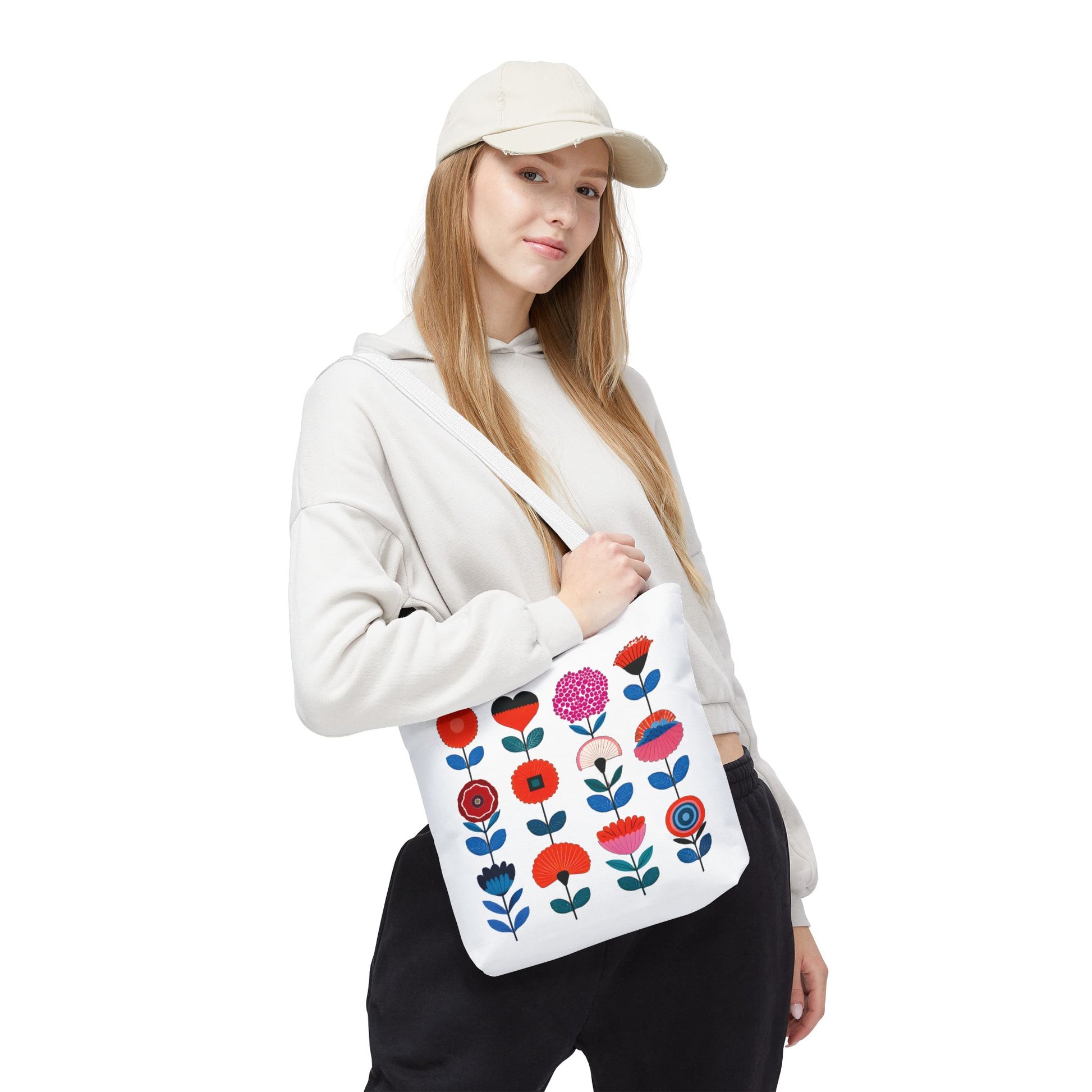 Woman holding a Floral Pattern Tote Bag with a pink flower and blue leaves, showcasing style and practicality for everyday use.