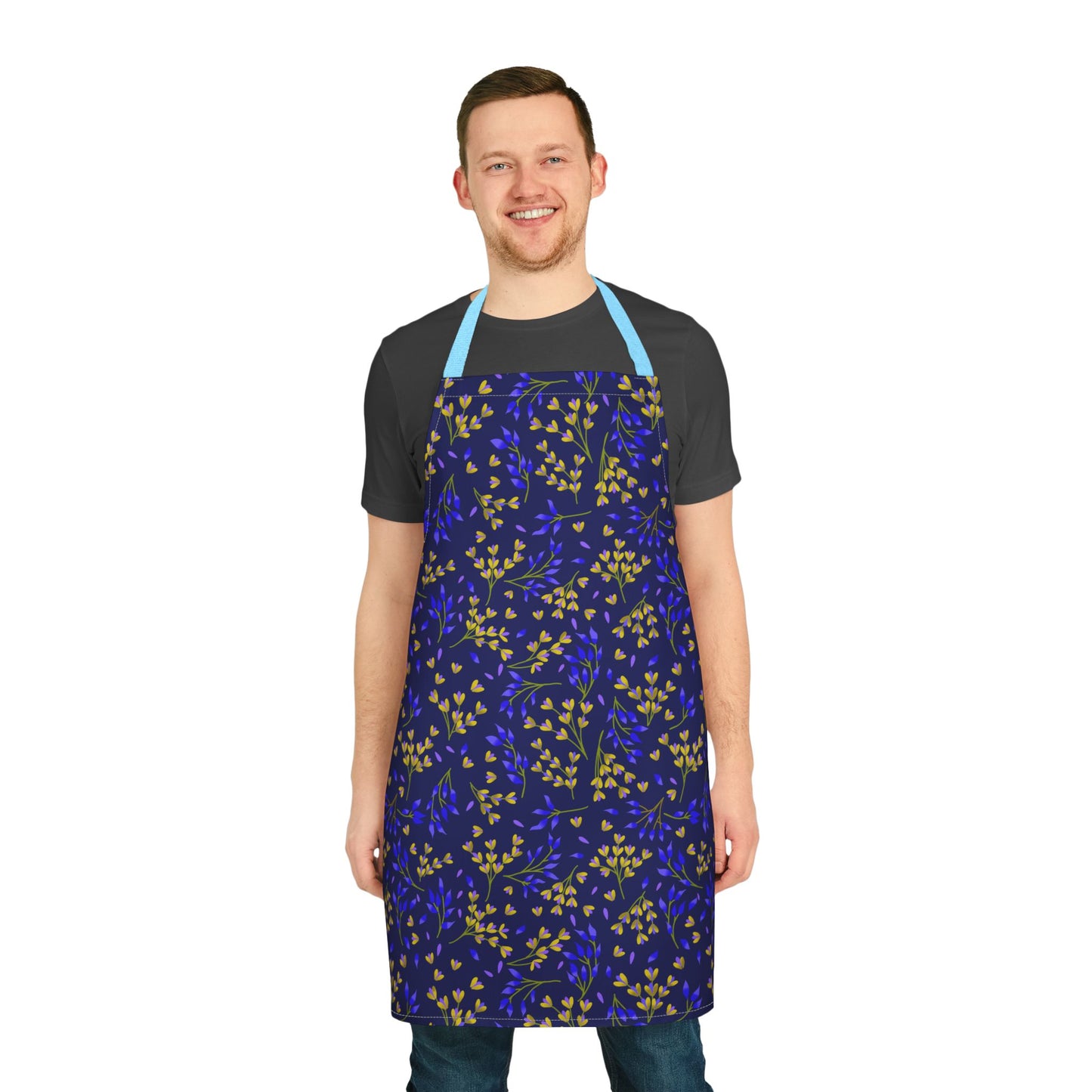 A man wearing the Floral Apron with a botanical pattern, featuring small leaves, smiling. The apron is designed for comfort and style, perfect for various activities, from FireBrook Essentials.