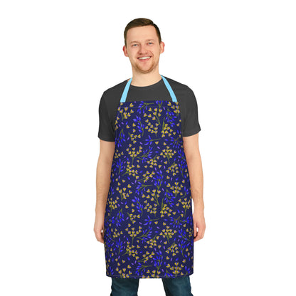 A man wearing the Floral Apron with a botanical pattern, featuring small leaves, smiling. The apron is designed for comfort and style, perfect for various activities, from FireBrook Essentials.