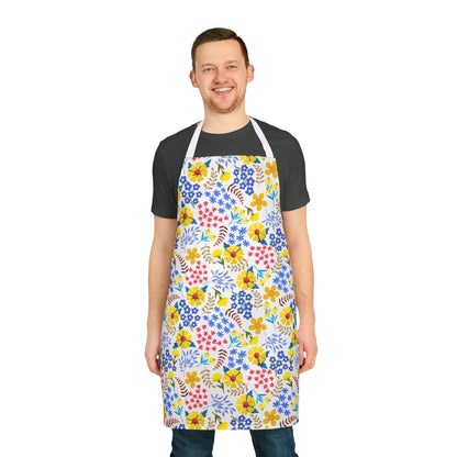 Man wearing Apron Floral Design over a dark T-shirt and jeans, showcasing vibrant floral patterns. This comfortable, stain-free apron from FireBrook Designs is perfect for various activities, enhancing joy and practicality.