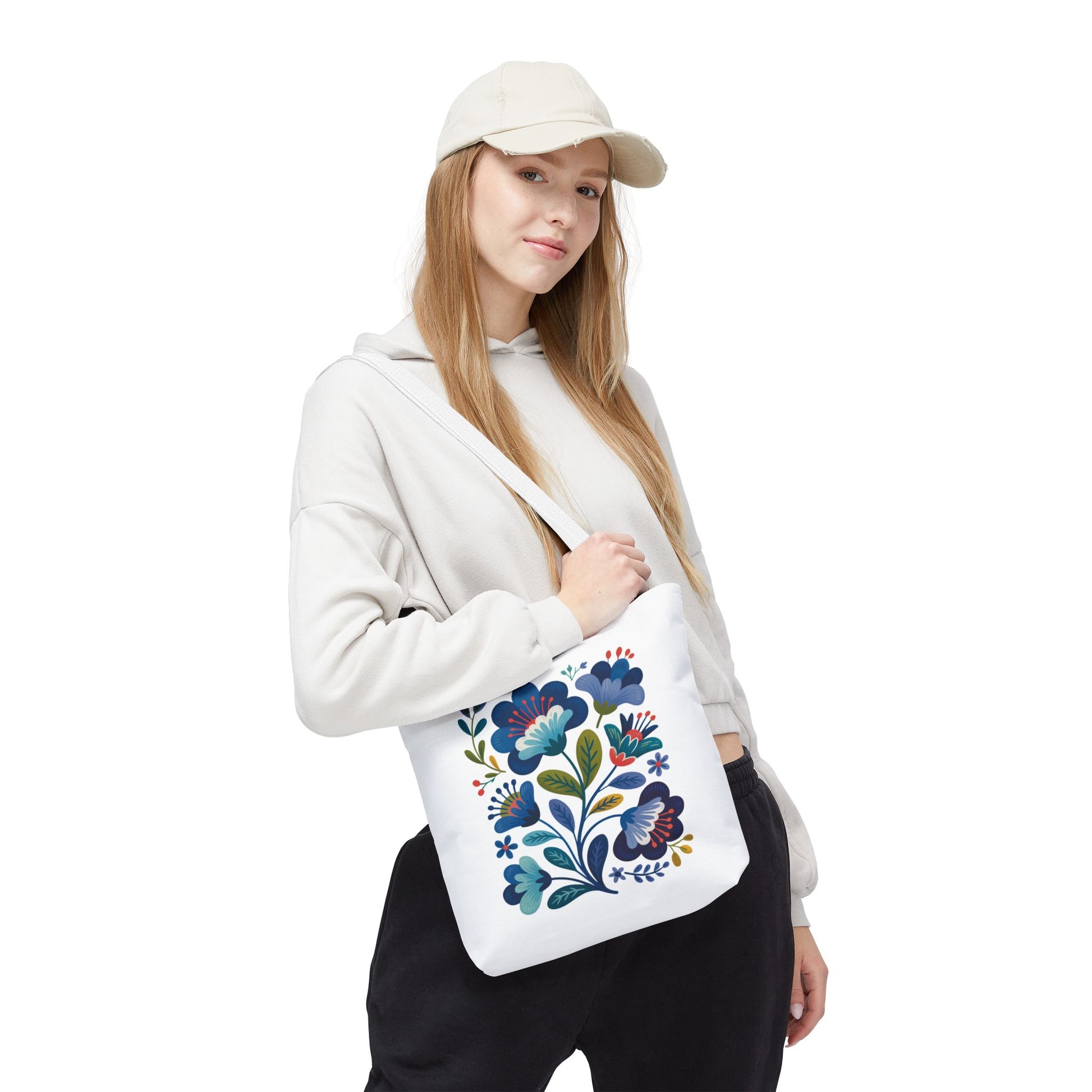 Vintage Folk Art Design Blue Floral Tote Bag with charming floral patterns, featuring reinforced black stitching, boxed corners, and polyester body. Ideal for everyday use or special occasions, reflecting FireBrook Essentials' uplifting style.