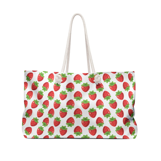 Strawberries Weekender Bag featuring playful strawberry patterns, ideal for joyful getaways. Includes durable rope handles, spacious interior, and sturdy T-bottom, embodying FireBrook Essentials' uplifting design ethos.