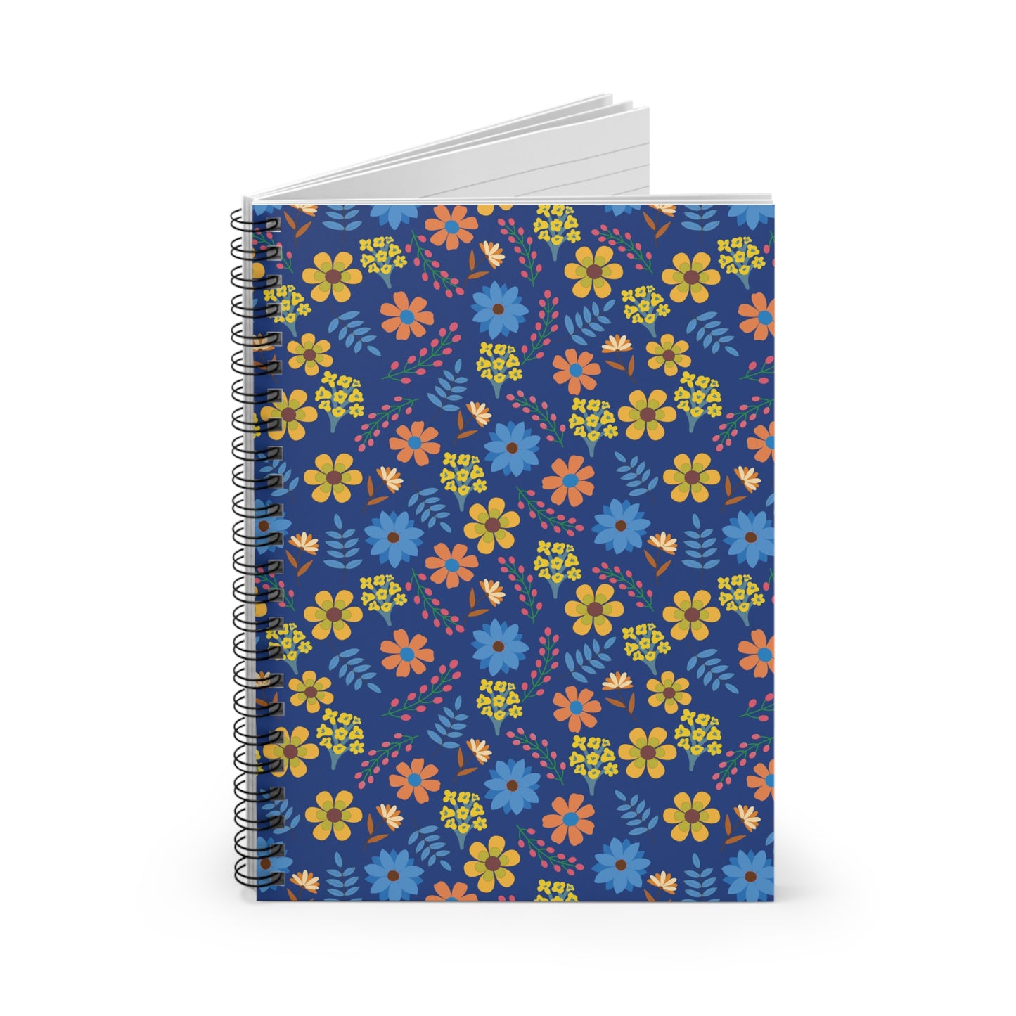 Floral Spiral Notebook with vibrant orange, yellow, and blue floral pattern on navy cover, standing upright. White, lined pages visible at top, embodying FireBrook Designs' cheerful and uplifting style.