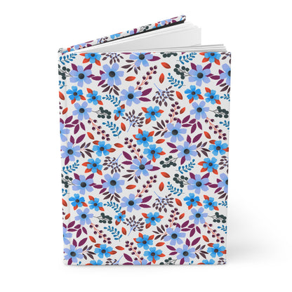HARDCOVER JOURNAL, MATTE, RULED, 5X7, SEWN BIND, CLEAN-TEAR PAGES – BLOOM BRIGHTLY, featuring a vibrant floral pattern, stands upright with slightly fanned pages, embodying FireBrook Essentials' joyful design ethos.