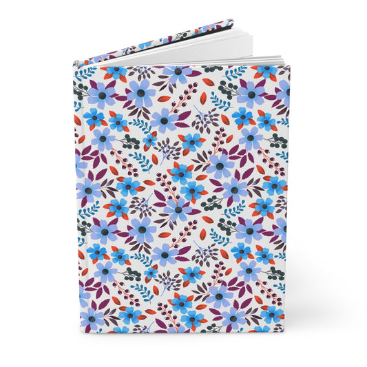 HARDCOVER JOURNAL, MATTE, RULED, 5X7, SEWN BIND, CLEAN-TEAR PAGES – BLOOM BRIGHTLY, featuring a vibrant floral pattern, stands upright with slightly fanned pages, embodying FireBrook Essentials' joyful design ethos.