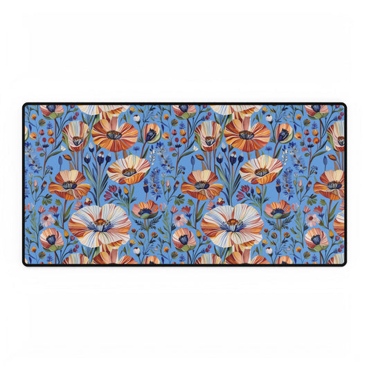 Desk Mats - Spring Wildflowers Poppy Cornflower Iris Design: A vibrant, nature-inspired desk mat featuring stylized orange, cream, and rust poppy-like flowers on a sky-blue background, bordered with a black stitched edge.