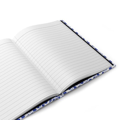 HARDCOVER JOURNAL, MATTE, RULED, 5X7, SEWN BIND, CLEAN-TEAR PAGES – INDIGO PETALS lies open, showcasing blank, lined pages and a blue floral-patterned cover, embodying FireBrook Essentials' uplifting design ethos.