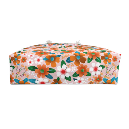 Rectangular Weekender Bag with floral-patterned pink fabric, featuring orange, white, and teal flowers. Two short ties are visible, ideal for stylish travel.