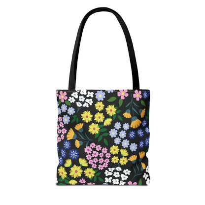 Starry Night Blooms Tote Bag featuring vibrant floral patterns on a black backdrop, with long black handles, embodies FireBrook Designs' essence of uplifting, stylish accessories perfect for summer outings and everyday use.