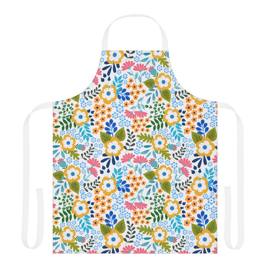 Floral Apron features a vibrant floral pattern with yellow, pink, and blue clusters on a white background. It includes white straps, offering a stylish and practical choice for culinary and craft activities.
