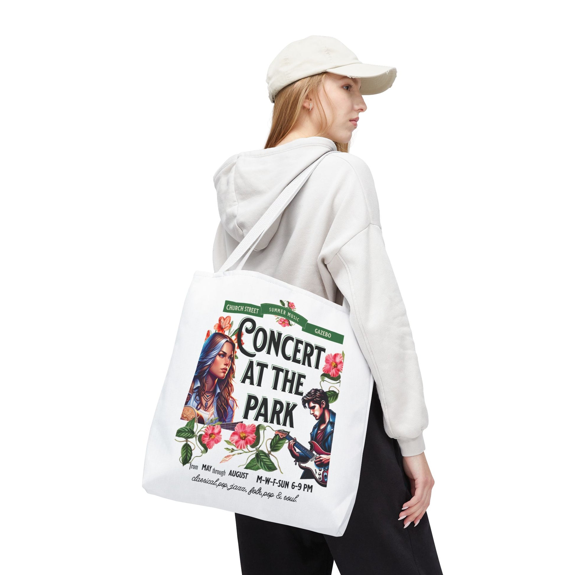 Concert At the Park Tote Bag featuring a lively concert scene, worn by a woman with a white hat, ideal for music lovers and outdoor events.