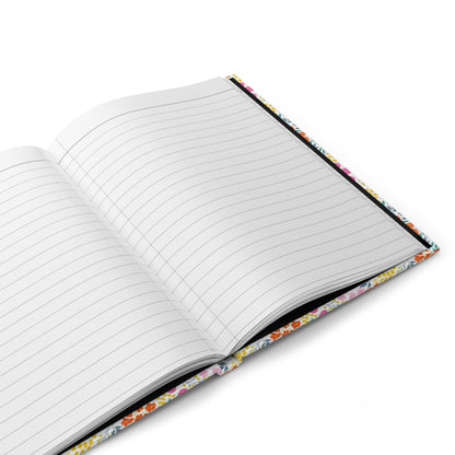 HARDCOVER JOURNAL, MATTE, RULED, 5X7, SEWN BIND, CLEAN-TEAR PAGES – FLORAL MOSAIC lies open, displaying blank, lined pages and a peek of its colorful floral-patterned hardcover, perfect for uplifting notes.