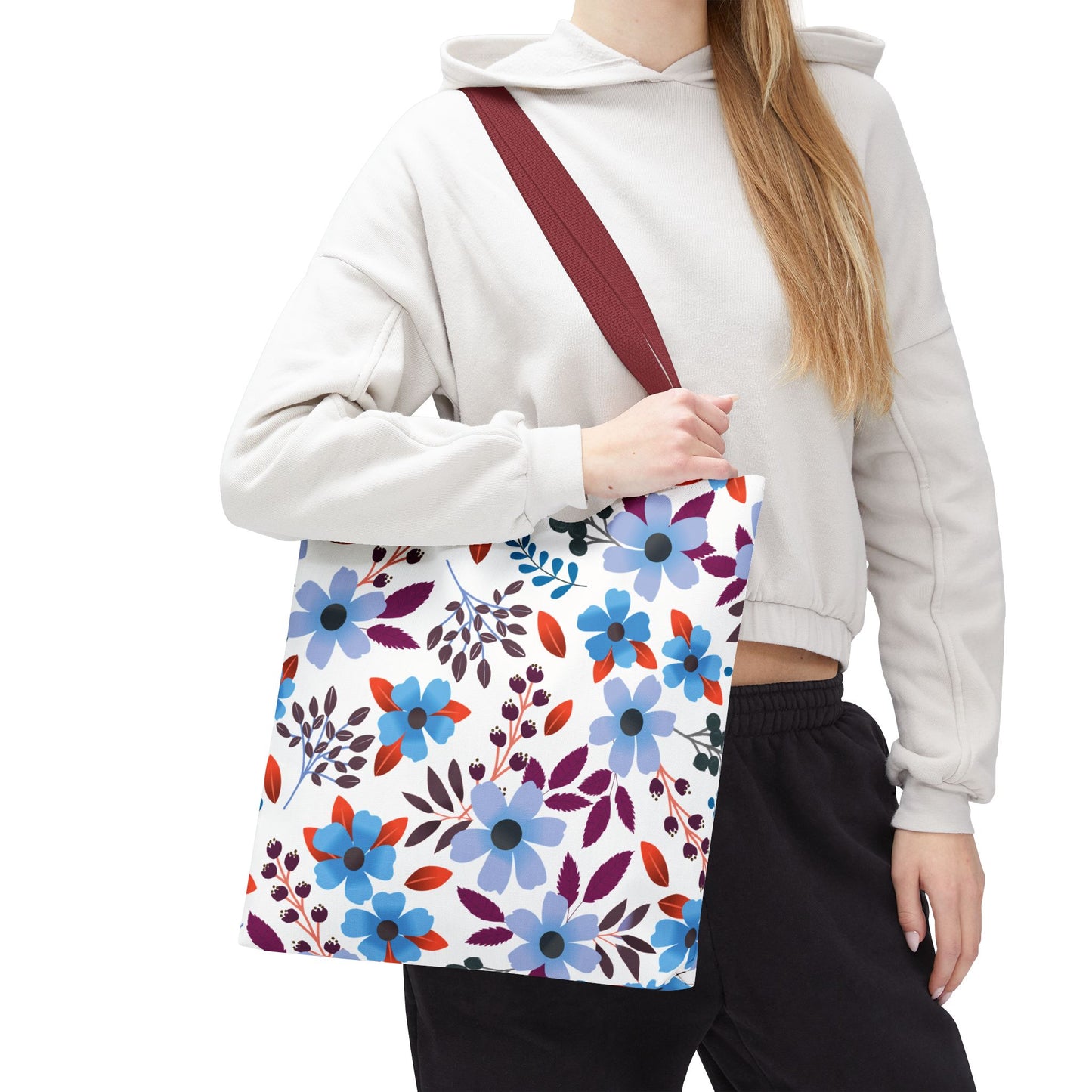 Floral Tote Bag featuring a vibrant pattern of stylized flowers and leaves, carried by a person in casual attire. This versatile tote exemplifies FireBrook Essentials' commitment to joyful and practical design.