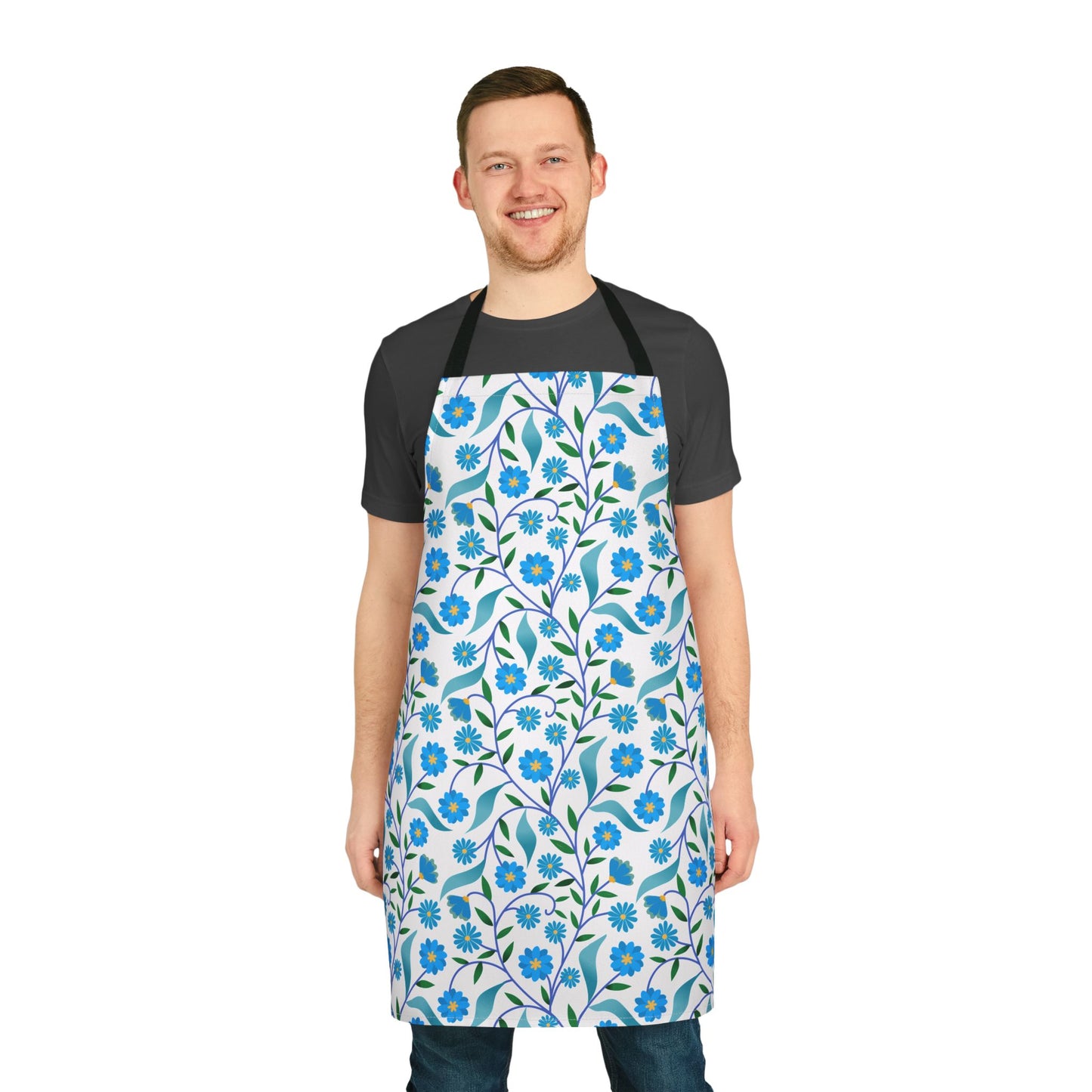 Man wearing Apron Floral Design with blue flowers and green leaves over dark-gray T-shirt and jeans, embodying FireBrook Essentials' blend of comfort and style for joyful daily activities.