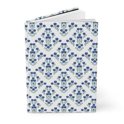 HARDCOVER JOURNAL, MATTE, RULED, 5X7, SEWN BIND, CLEAN-TEAR PAGES – INDIGO DAISY features a white cover adorned with a seamless pattern of blue flowers, showcasing its elegant, durable design for uplifting daily use.