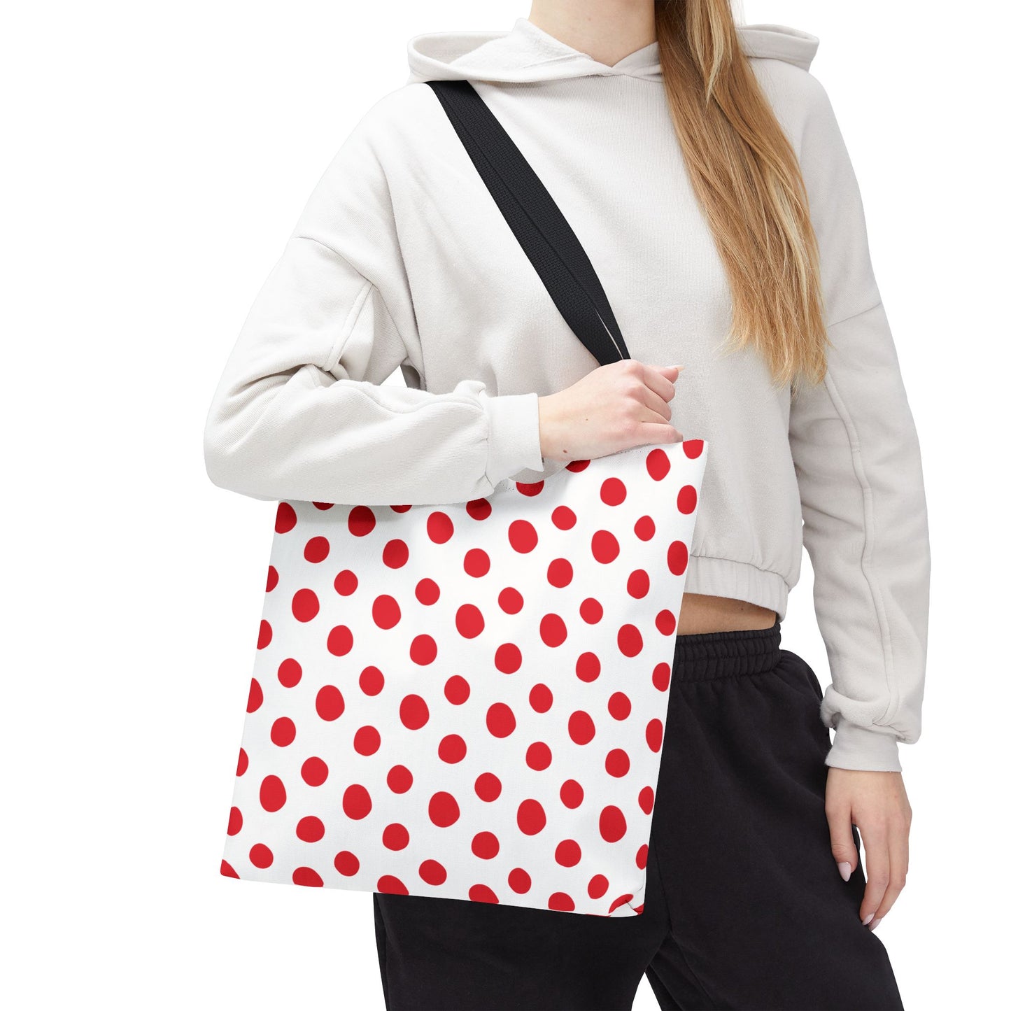 Red Polka Dots Tote Bag held by a woman, showcasing its playful red and white design. Perfect for everyday use, it embodies FireBrook Essentials' joyful and stylish approach to fashion.