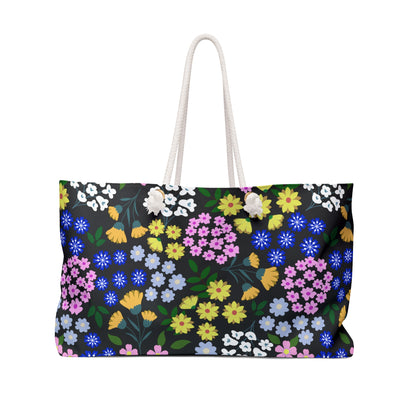 Weekender Bag with white rope handles and vibrant floral pattern, ideal for stylish travel. Features spun polyester material, cream interior, and T-bottom design for ample storage. Perfect for joyful getaways.