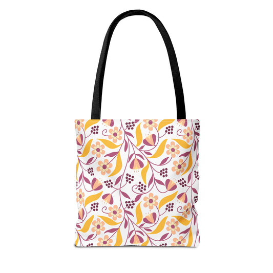 Floral Tote Bag with vibrant peach, rose-pink, and golden yellow floral-and-leaf pattern on white, featuring black straps. Ideal for summer outings, embodying FireBrook Designs' cheerful and stylish essence.