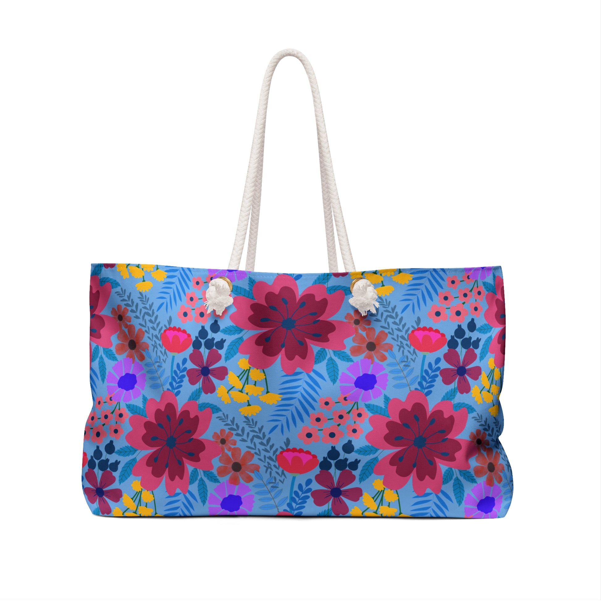 Weekender Bag with vibrant floral design, large rectangular shape, thick white rope handles, and a light blue background, perfect for stylish travel.