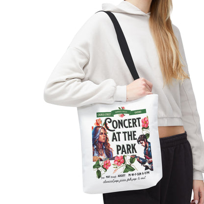 Concert At the Park Tote Bag featuring a lively concert design, held by a woman, ideal for music lovers and outdoor activities.