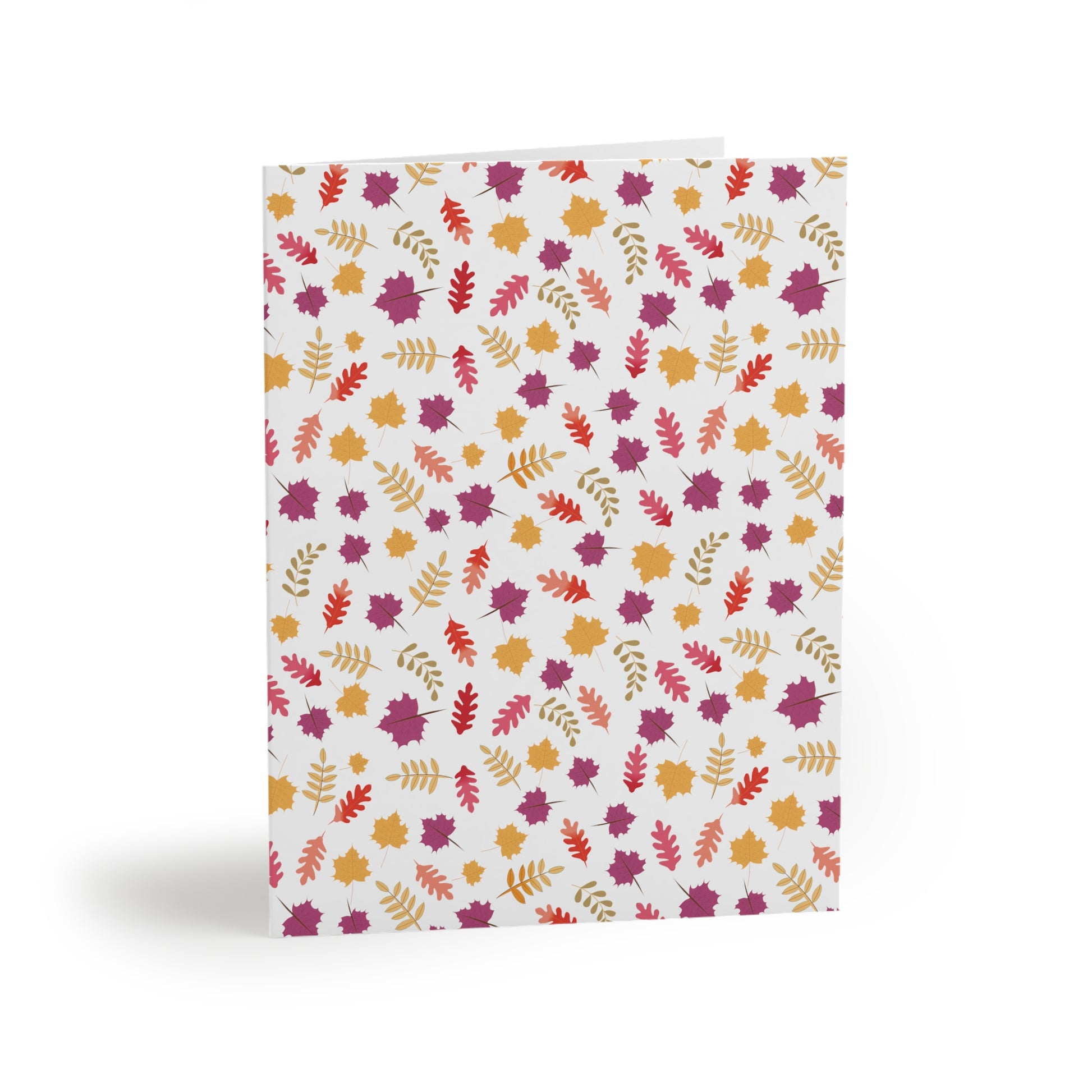 Autumn Greeting Cards — Pack of 8/16/24, featuring a folded design with an all-over autumn-leaf pattern in warm colors, capturing the essence of fall. Includes a matching white envelope for personal messages.