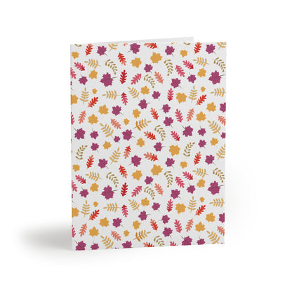 Autumn Greeting Cards — Pack of 8/16/24 feature a folded cardstock with a vibrant autumn-leaf pattern in orange and purple tones. Each card includes a matching white envelope, perfect for sending thoughtful messages.