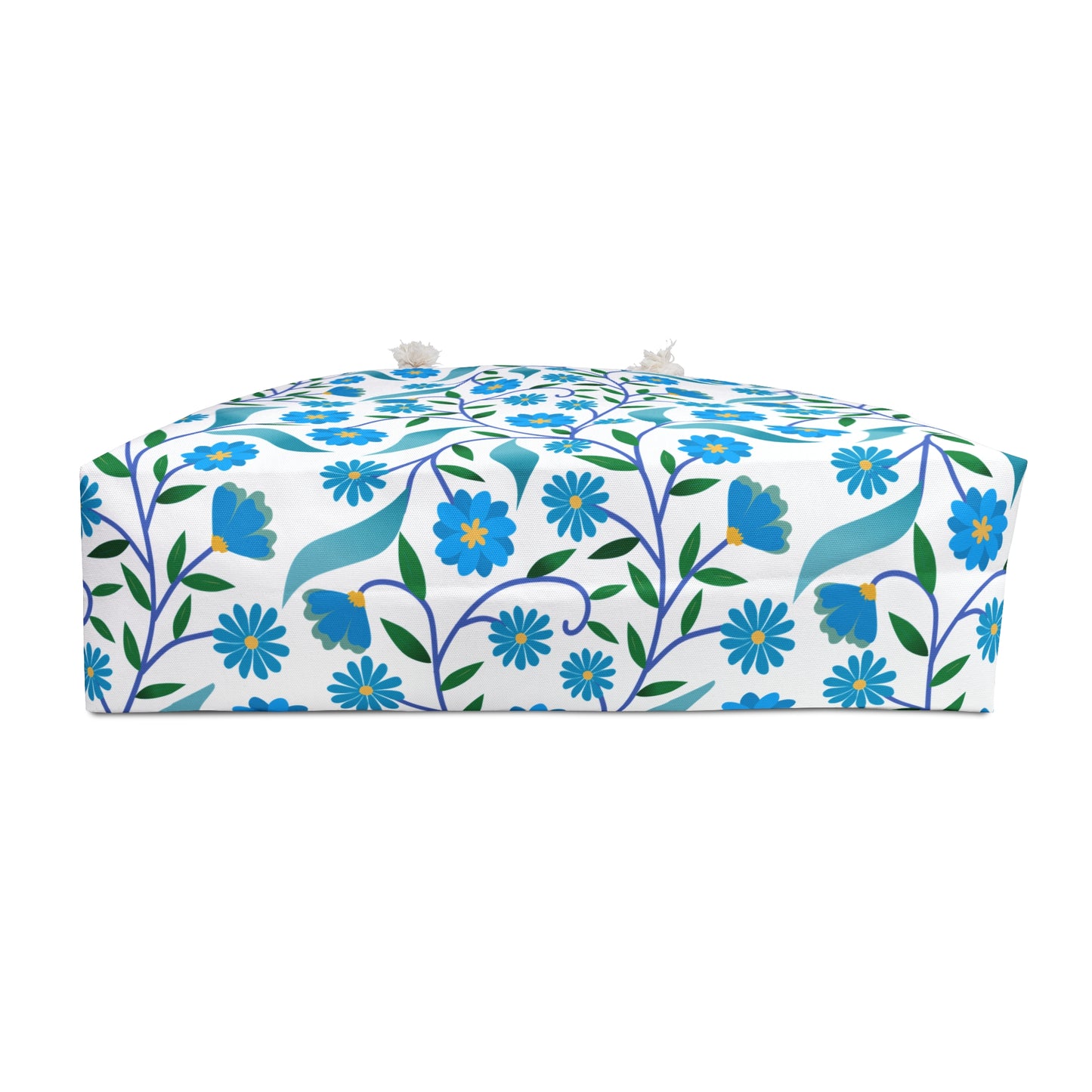 Weekender Bag with a white fabric cube design, featuring blue flowers, green leaves, and rope handles. Ideal for stylish travel, aligning with FireBrook Essentials' commitment to uplifting, comfortable designs.