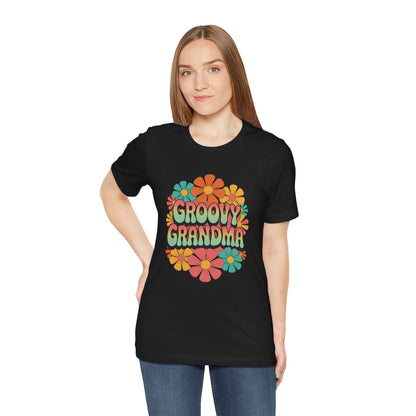 Groovy Grandma for Mother's Day Bella+Canvas Unisex T-Shirt featuring a vibrant floral design, worn by a woman with blonde hair. Stylish and playful, perfect for vintage-loving grandmas.