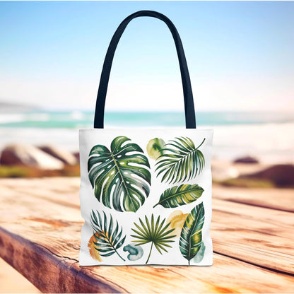 Tropical Leaves Tote Bag, featuring a vibrant green leaf design on a white background, offers a spacious, durable carry option with reinforced black-stitched handles, ideal for beach outings and everyday use.