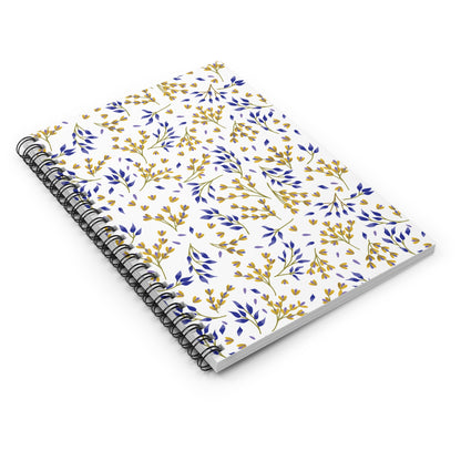 Floral Spiral Notebook featuring a white cover with a botanical pattern in deep blue and golden yellow sprigs and leaves, complemented by a sleek black metal coil binding for easy page turning.