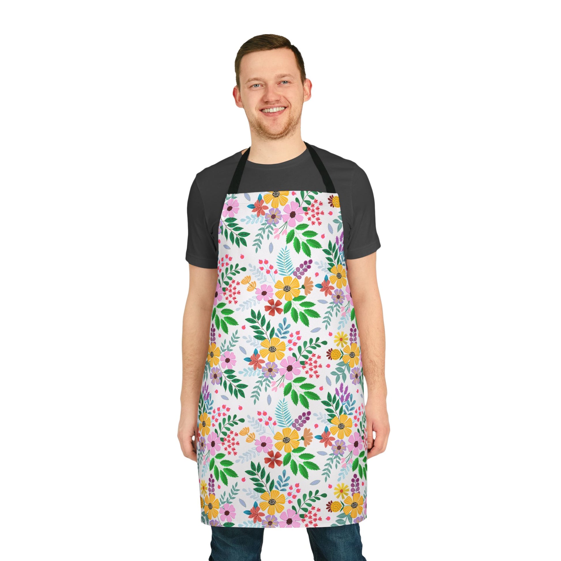 Man wearing FireBrook Designs' Floral Apron, featuring vibrant floral patterns against white. Appears comfortable and stylish, ideal for various activities. The apron has a tie-back closure and stain-free polyester material.