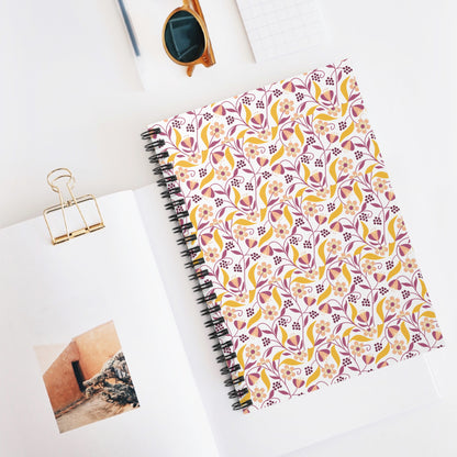 Floral Spiral Notebook with a vibrant floral cover, featuring mustard yellow, dusty rose, and burgundy tones, sits on a minimalist workspace, embodying FireBrook Designs' blend of style and joyful creativity.