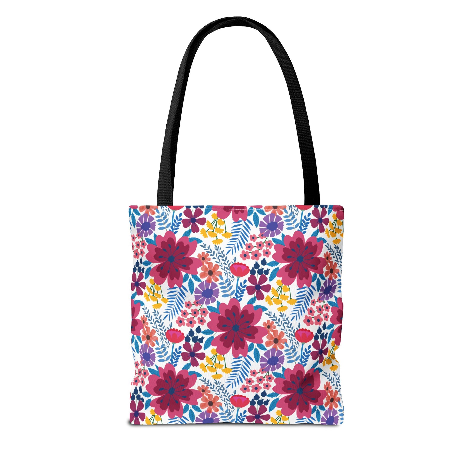 Violet Daisy Carnival Tote Bag with black straps features a vibrant floral pattern of pink, purple, and yellow blooms, ideal for summer outings. Durable polyester with reinforced stitching and boxed corners for extra space.