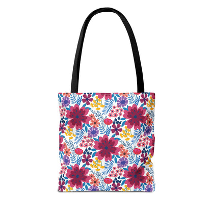 Violet Daisy Carnival Tote Bag with black straps features a vibrant floral pattern of pink, purple, and yellow blooms, ideal for summer outings. Durable polyester with reinforced stitching and boxed corners for extra space.
