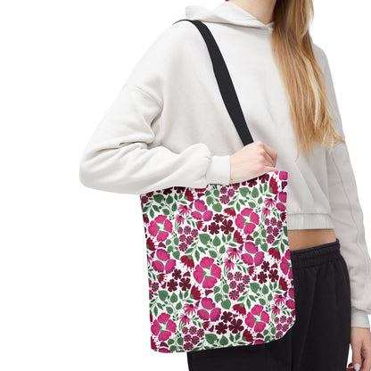 Person wearing a cropped hoodie and dark pants carries the Pink Lady Tote Bag, featuring a vibrant floral pattern of bright pink and burgundy blossoms, embodying FireBrook Designs' joyful, stylish essence.