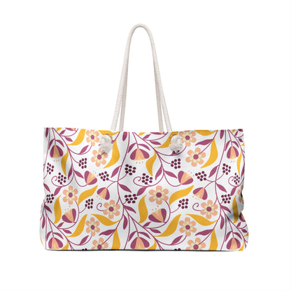 Weekender Bag with thick white rope handles, featuring a stylized floral-and-vine pattern in warm tones on a white background, designed for stylish travel and spacious storage.