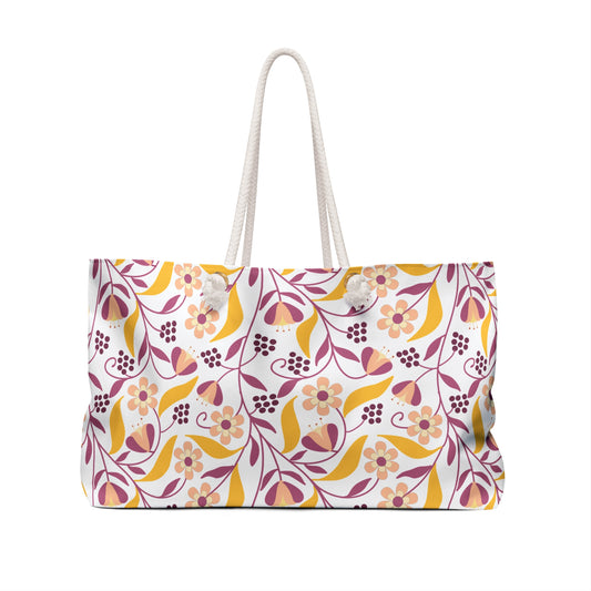 Weekender Bag with thick white rope handles, featuring a stylized floral-and-vine pattern in warm tones on a white background, designed for stylish travel and spacious storage.