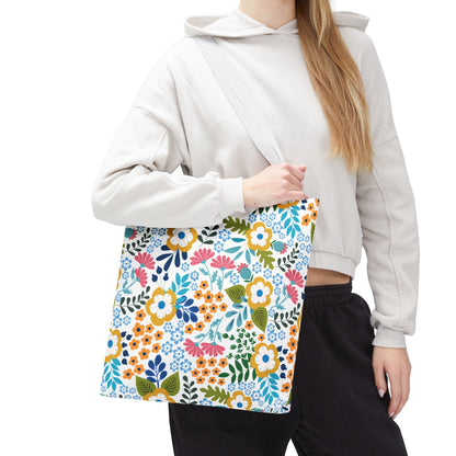 Floral Tote Bag with colorful blooms and leaves, perfect for brightening summer outings. The bag, draped over a shoulder, showcases its spaciousness and durability, embodying FireBrook Designs' joyful, stylish essence.