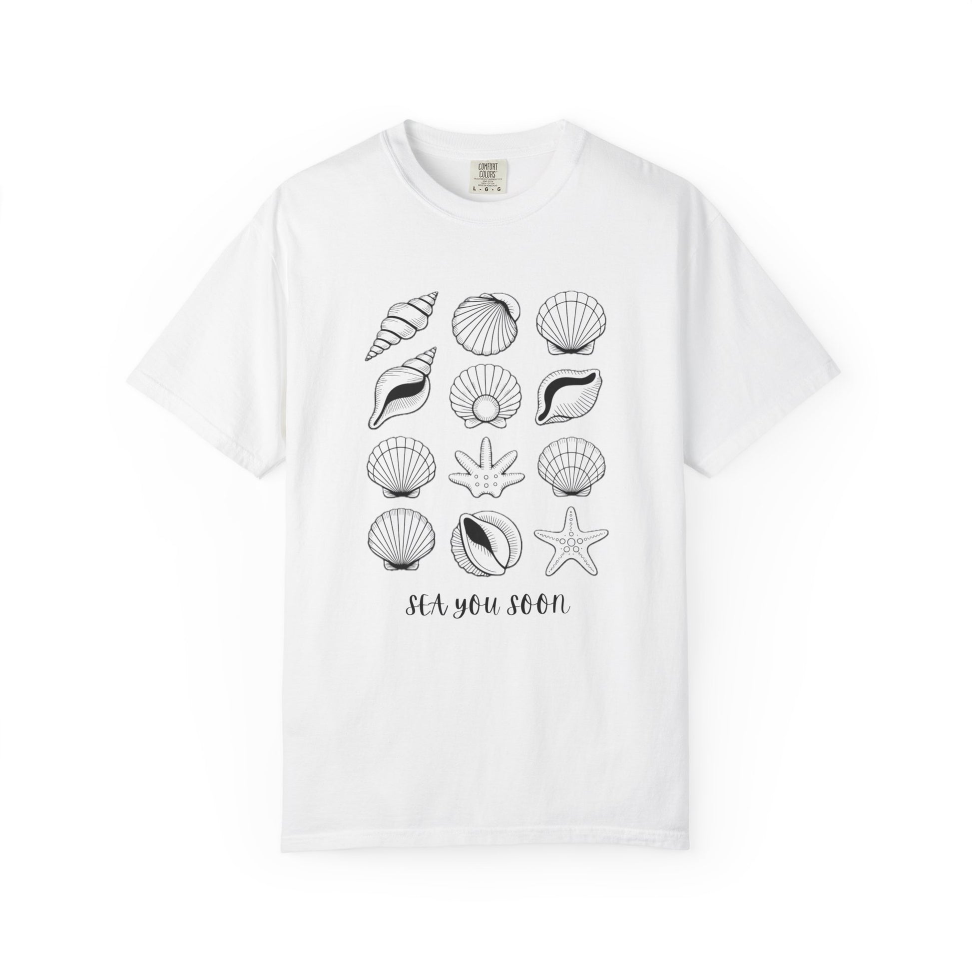 Seashells and Sea You Soon T-Shirt featuring a seashell design and uplifting text, embodies a relaxed beach vibe perfect for ocean lovers, crafted with durable, ethically sourced US cotton for comfort.